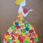 Pani Jesień w sukni i kapeluszu z kolorowych papierowych liści